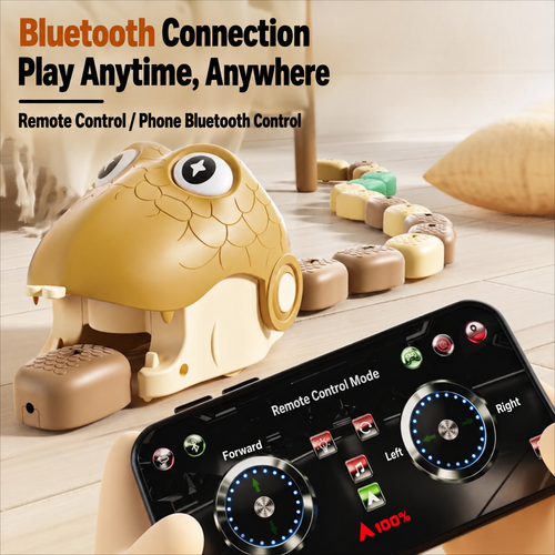 A beige and cream robotic snake toy with a large eye head and segmented body, shown on a wooden floor with a smartphone displaying a remote-control app interface in the foreground. Text at the top reads 'Bluetooth Connection Play Anytime, Anywhere' and 'Remote Control / Phone Bluetooth Control.